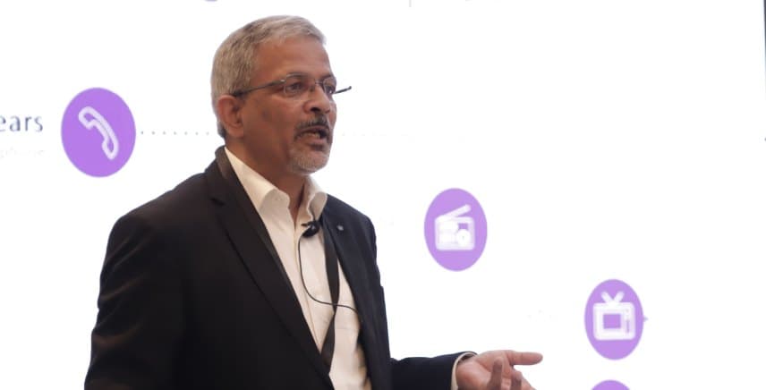 Rajiv Srivastava speaking on stage